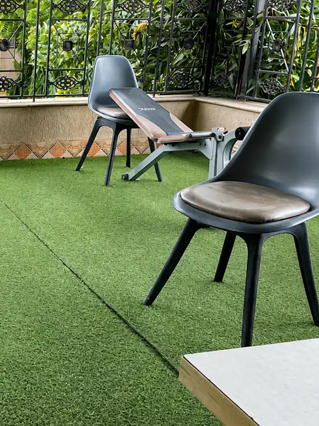 Outdoor balcony fitness and gym training turf at Pune Centre Hostel