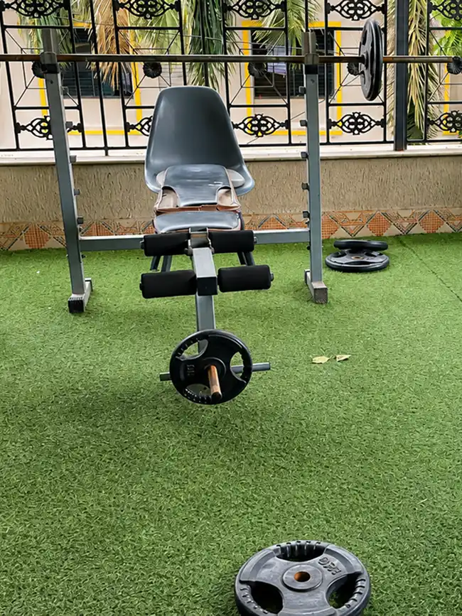 Strength training gym workout equipment at Pune Centre Hostel