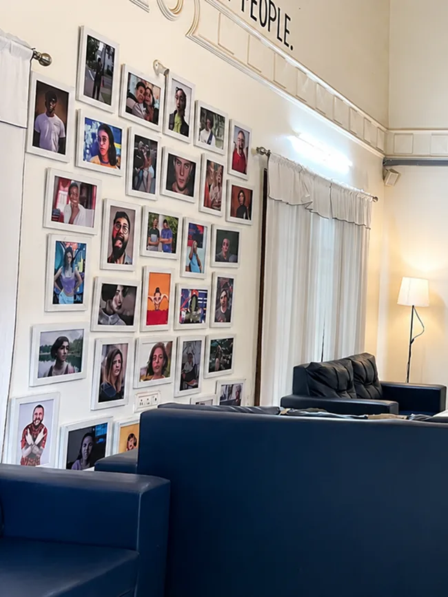 Lounge gallery wall featuring memorable photos at Pune Centre Hostel